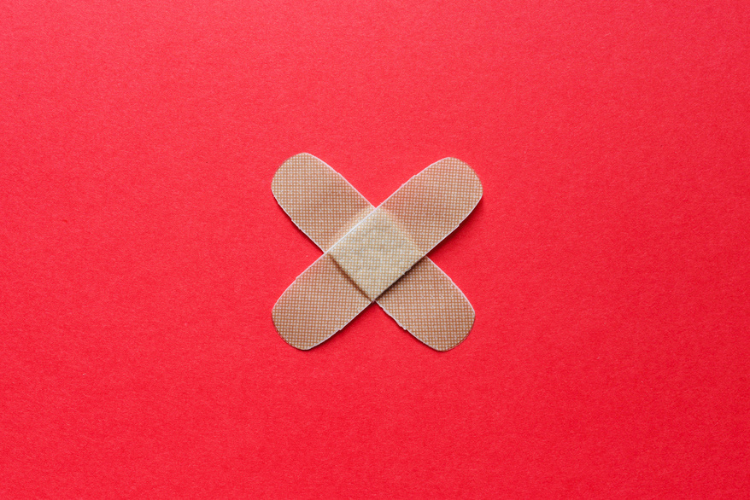 Stock image of two bandages in a cross shape.