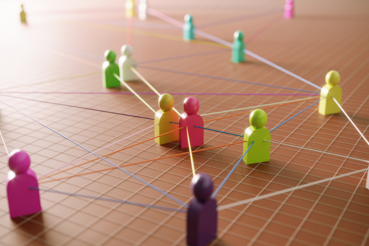 Colorful, abstract figures are interconnected by lines on a grid, symbolizing a network of leadership.