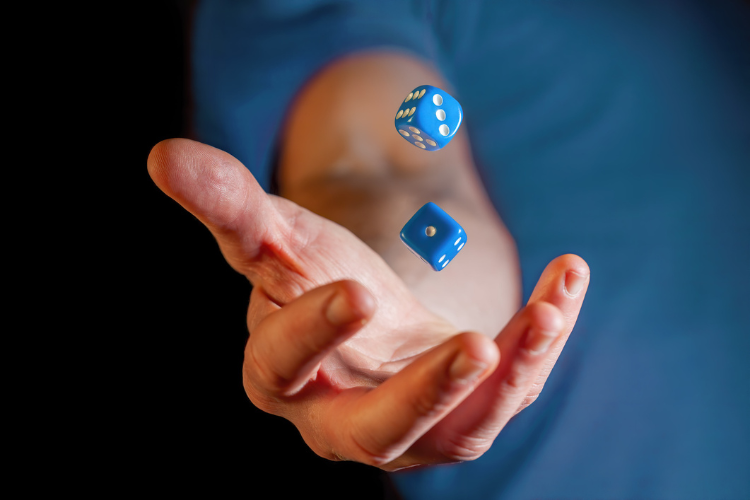 stock image of man holding dice