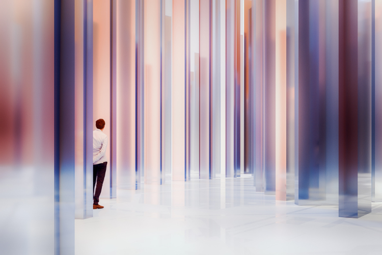 Stock illustration of a businessman standing behind several glass columns