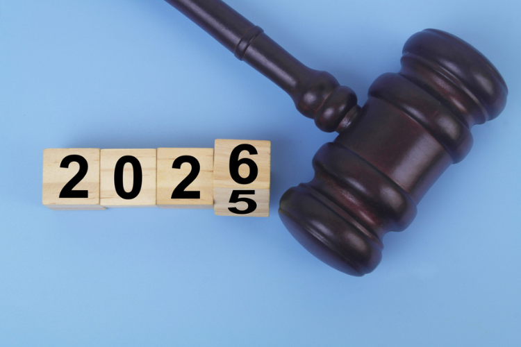 Wooden judge gavel and flipping numbers 2025 and 2026 on cubes