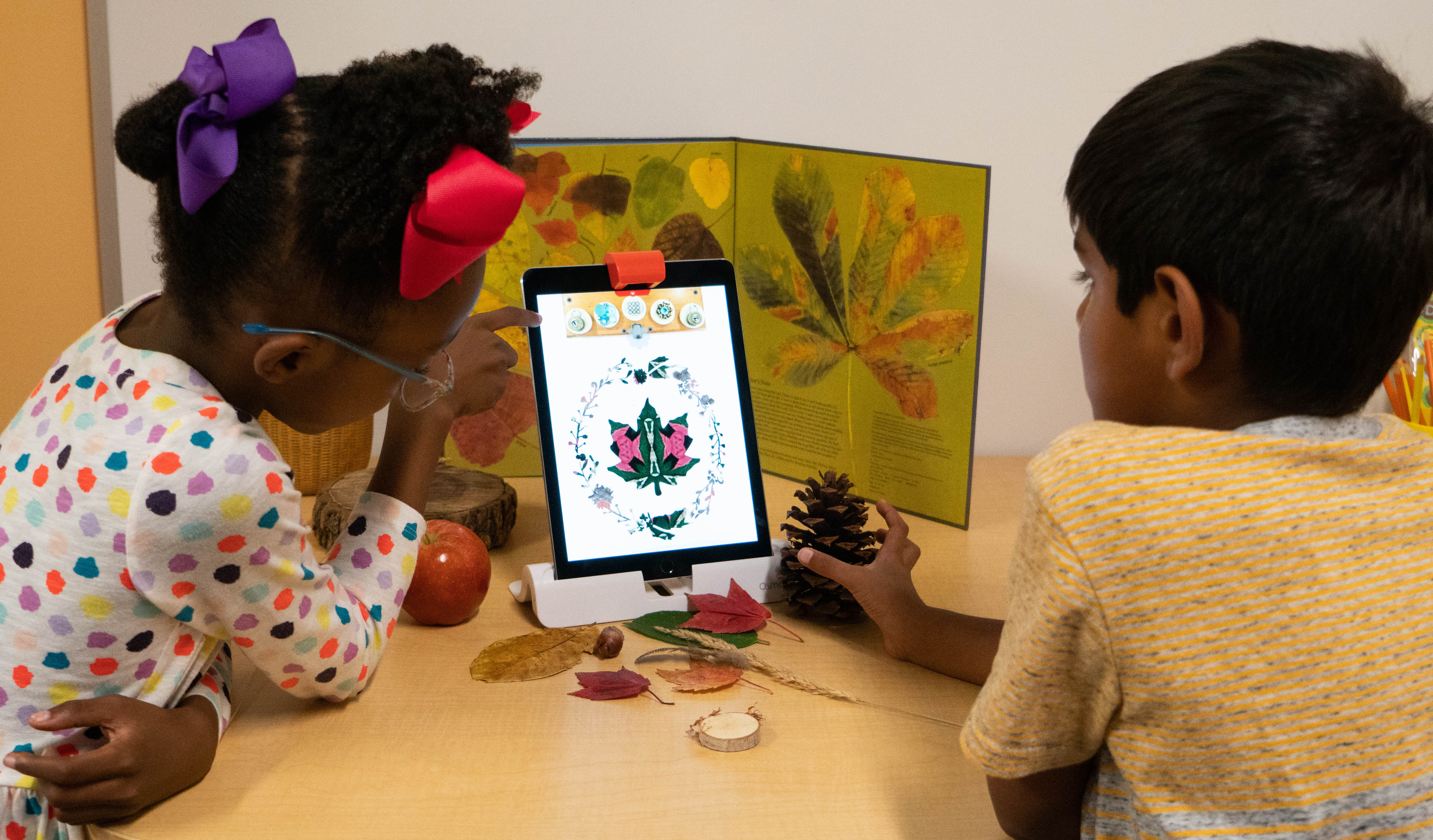 Students at Bennett Day School try a fall stencil when using colorful leaves, acorns, and pine cones with Osmo Kaleidoscope