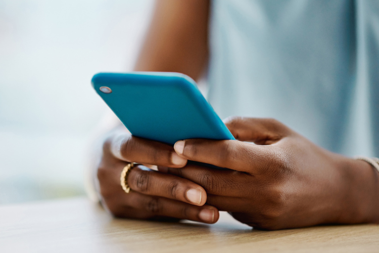 Black woman using a cellphone in an office
